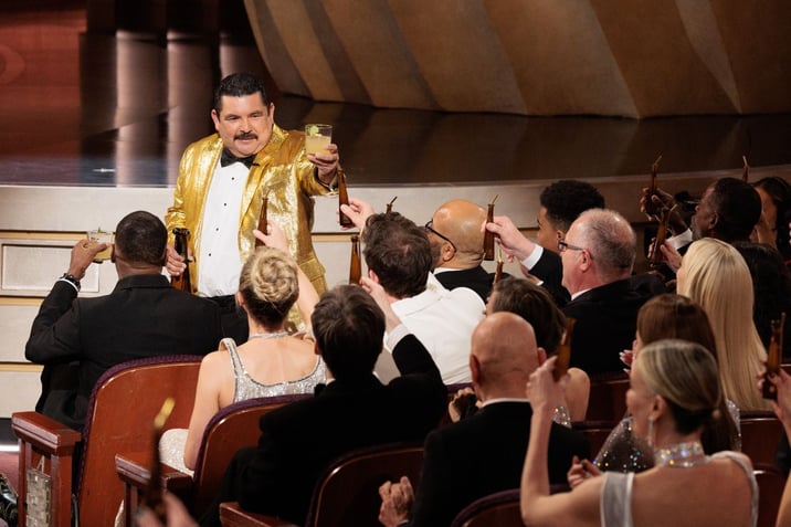 Jimmy Kimmel and Guillermo Rodriguez toast, holding drinks made with Don Julio 1942